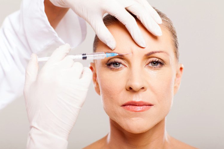 cosmetic surgeon giving face lifting injection