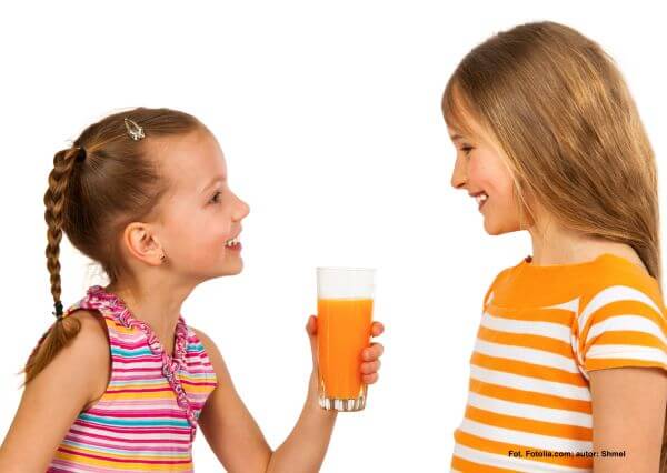 Happy kids drinking juice