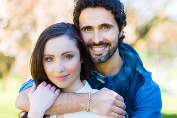 Young couple relaxing on the grass in the park