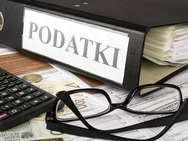 Filling in polish individual income tax form PIT with money and pen