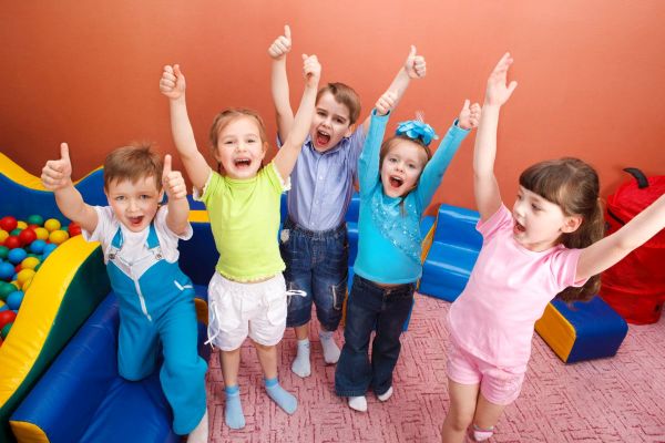 Group of shouting kids with hands up