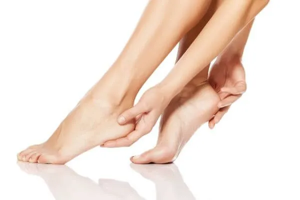 woman tenderly touching her feet
