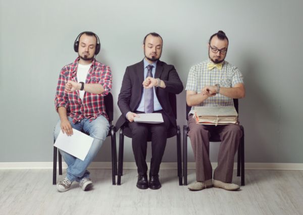 Conceptual image of three men waiting for an interview