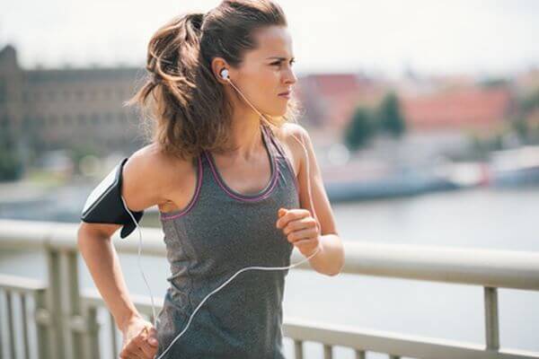 Rock on, run on, power through. That is the stuff of champions. A brunette, long-haired jogger is deep in thought, focused on her goal and being motivated by her the music she is listening to.