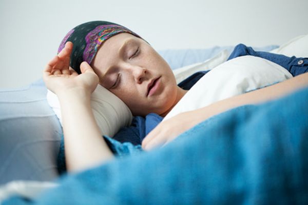 Close-up of young woman having tumor sleeping