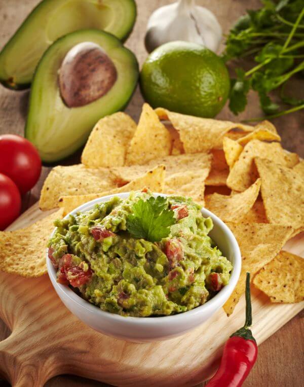 Ingredients for avocado guacamole dip and nachos
