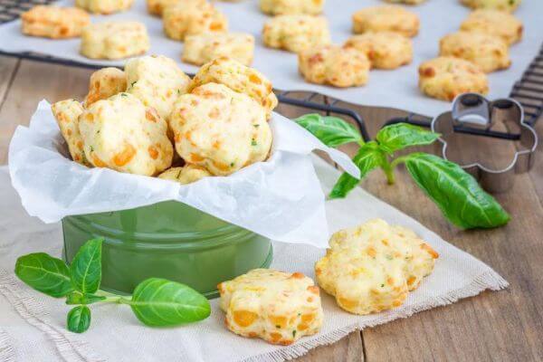 47675566 - fresh baked cheese cookies with basil, closeup
