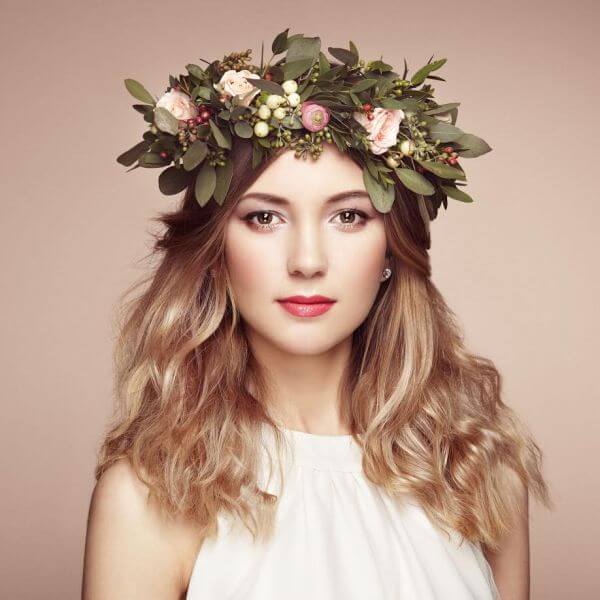 54978512 - beautiful blonde woman with flower wreath on her head. beauty girl with flowers hairstyle. perfect makeup. beauty fashion. spring woman